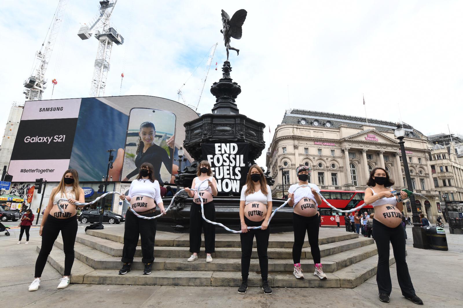 Six Pregnant Women Bare Their Bumps At Piccadilly Circus Demanding An End To Fossil Fuels