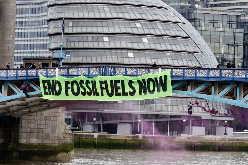end fossil fuels now banner at Tower Bridge
