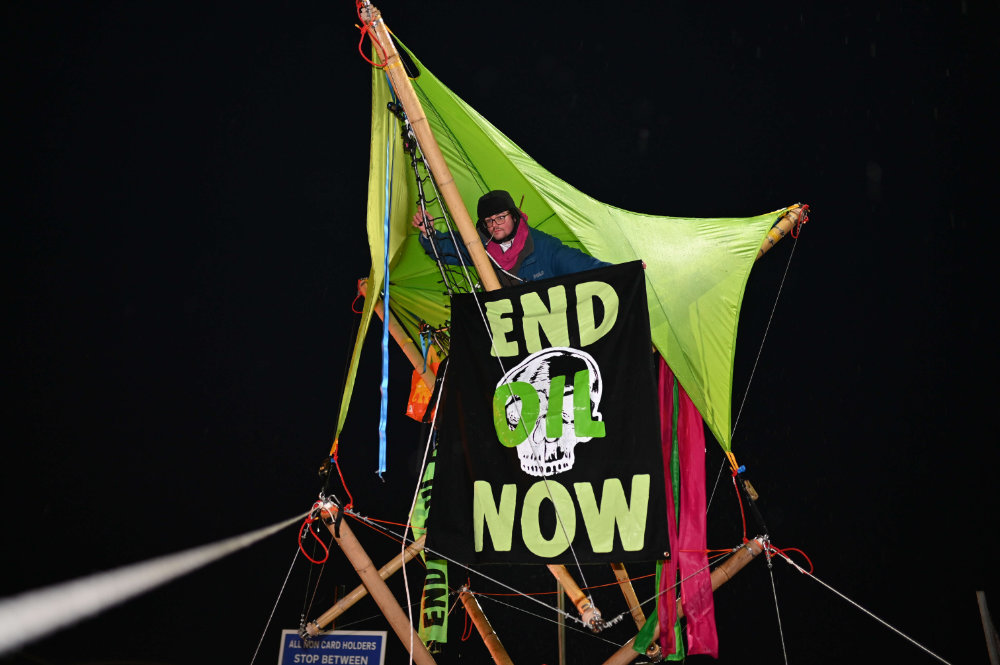 Stanwell, UK. 4 April 2022. Extinction Rebellion protesters blocked the entrance to Esso West London Terminal near Heathrow Airport. Protesters erected two wooden structures to block the transit of fuel delivery vehicles. Protesters demand an end to fossil fuels.