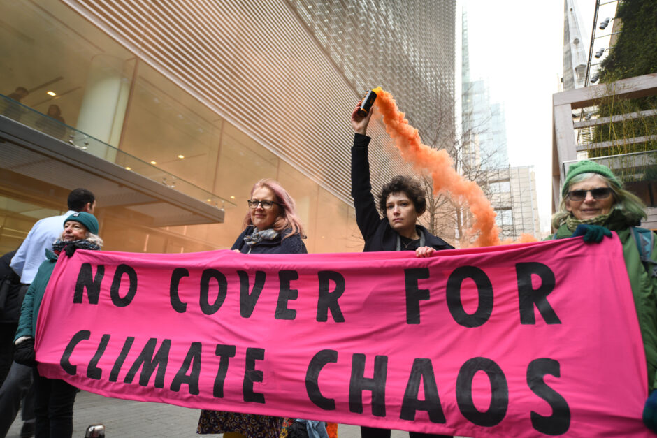 Rebels holding No Cover For Climate Chaos banner in City of London amid occupations of insurance buildings