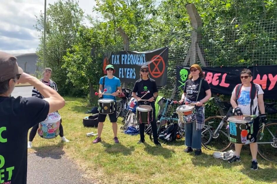 Protesters holding a banner at Farnborough airport
